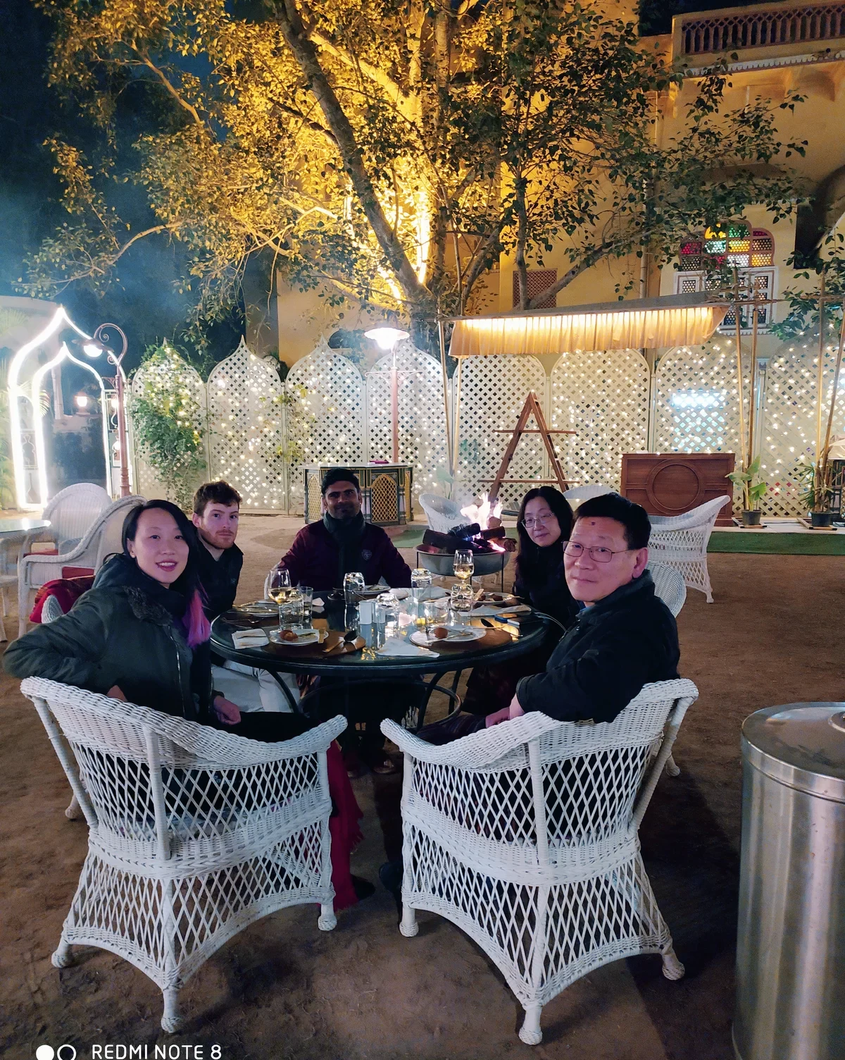 Guests enjoying private candlelight dinner in Rajasthan heritage palace courtyard